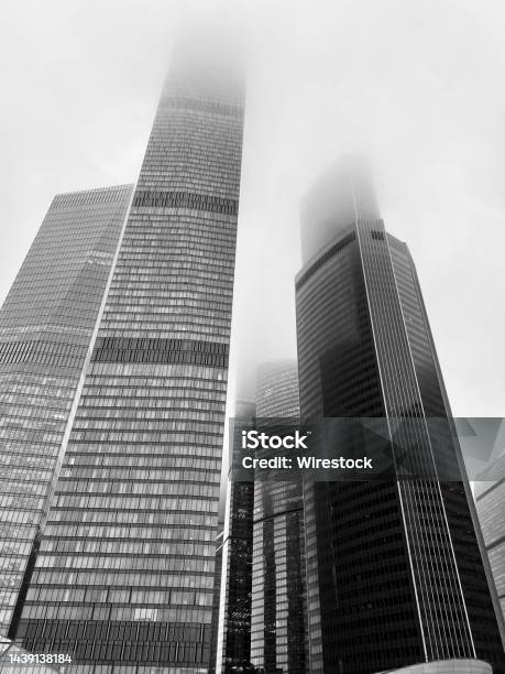 Vertical Greyscale Shot Of High Rise Modern Business Buildings Stock Photo - Download Image Now
