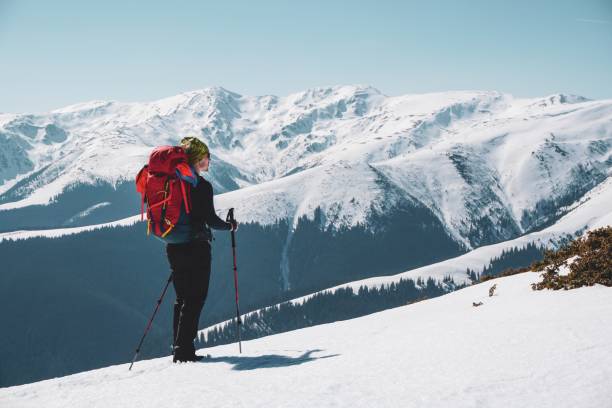 istock Male mountain climber enjoying  the snow covered mountain view from the summit 1439138317