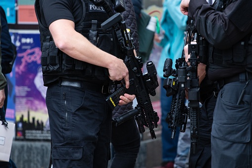 leeds, United Kingdom – May 05, 2019: Horizontal shot of armed police patrolling tour de yorkshire crowd to keep everyone safe