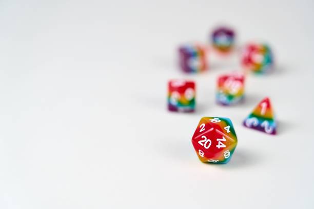 Rainbow dice illustrating the concept of LGBTQ representation and inclusion in tabletop RPG gaming A set of 7 dice used for role playing games which have recently seen an increase in representation and inclusion of diverse players. developing 8 stock pictures, royalty-free photos & images