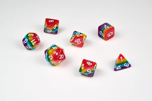 Rainbow dice illustrating the concept of LGBTQ representation and inclusion in tabletop RPG gaming A set of 7 dice used for role playing games which have recently seen an increase in representation and inclusion of diverse players. developing 8 stock pictures, royalty-free photos & images