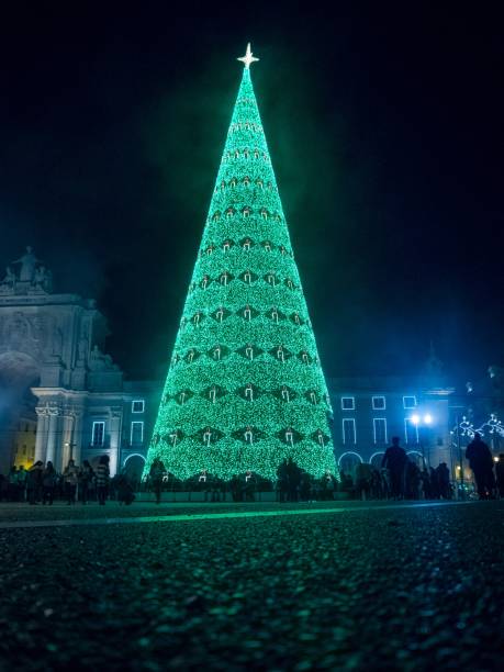 istock Christmas tree decorated with lights during the night in Commerce square in Lisbon 1439140111