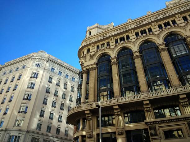 istock Low angle shot of buildings in Spain under a clear blue sky 1439140837