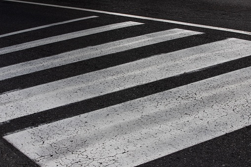 A white zebra crossing on the street of Bergamo in Italy