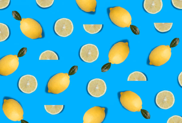 istock Whole and sliced lemon on the blue background. Flat lay. Pattern. Top view. 1439141322