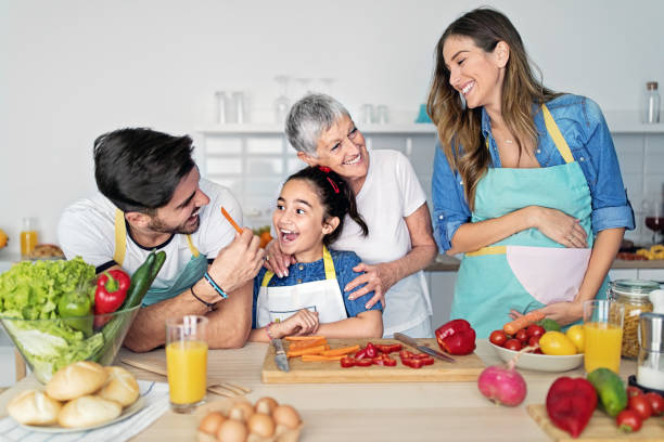 istock Happy family cooking together in a kitchen 1439141525