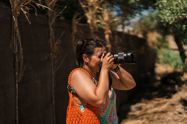 Young woman photographing on a professional camera