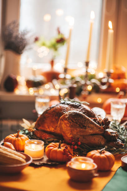 istock Thanksgiving holiday dinner table setting with fall decoration and pumpkins 1439144218