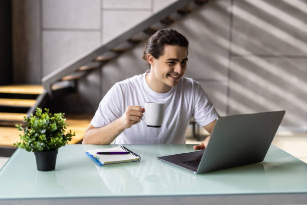 istock Freelancer man working at home drinking coffee from home 1439145842