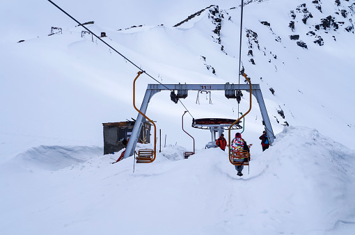 CHEGET , RUSSIA - May 9, 2015, Chairlift or ski lift in snow mountains in bright winter day