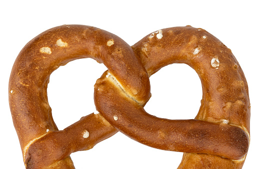 A fresh Bavarian pretzel isolated on white background. The pretzel is a traditional Bavarian pastry and is a popular snack.