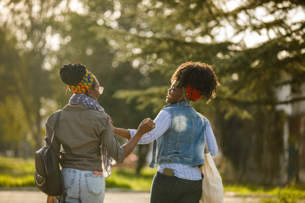 istock Two girlfriends returning from the farmer's market, chatting and bonding 1439156040