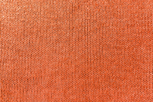 istock Knitted orange pattern closeup, detailed yarn background. 1439160903