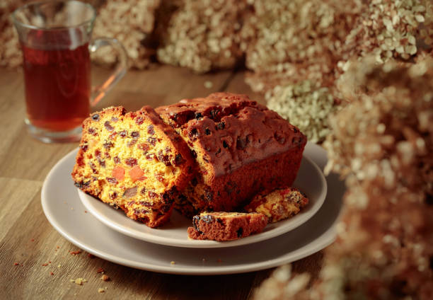Summer dessert. Raisin cake, cup of tea and bouquet of forsythia, rustic style on wooden background