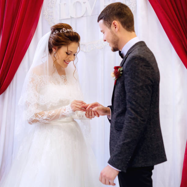 istock The bride's girlfriend watches as the bride wears a wedding ring 1439162579