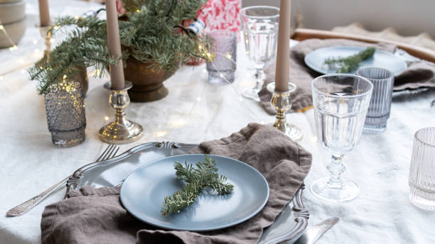 istock Festive table setting for Christmas. Christmas decor for cafe, restaurant, dining room. Spruce twigs for dining table decor. Linen napkins and tablecloths. Christmas table setting ideas. 1439165106