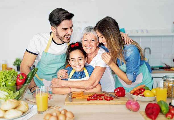 istock Happy family cooking together in a kitchen 1439166180