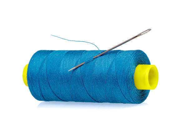 istock Macro skein of blue thread with a needle on a white background 1439166196