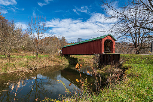 Graysville, Ohio, USA- Oct. 25, 2022: Foraker Covered Bridge spanning the Little Muskingum River on a beautiful autumn day in rural Monroe County.