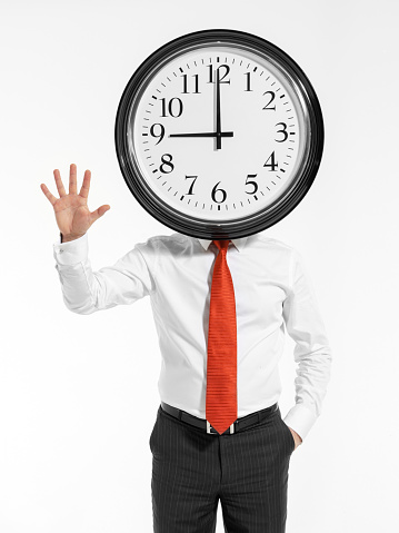 Businessman holding clock in front of their heads