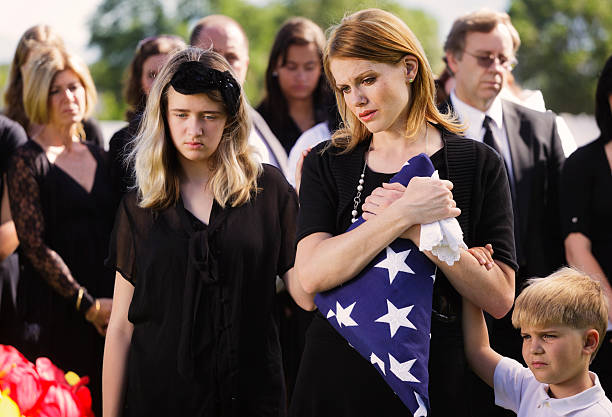 Family at a Funeral A mother and two children standing graveside at a funeral. child casket stock pictures, royalty-free photos & images