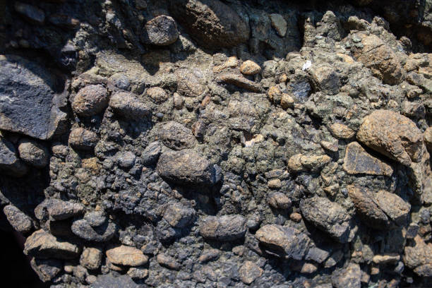 istock Natural stone background with rough textured surface. Sea rock texture. close-up. Blurred and defocused background. 1439169784