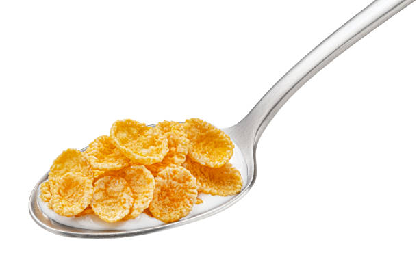 istock Corn flakes with milk in spoon isolated on white background 1439169924