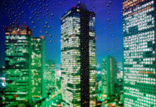 Closeup modern corporate glass building with reflection of the city, background with copy space, full frame horizontal composition