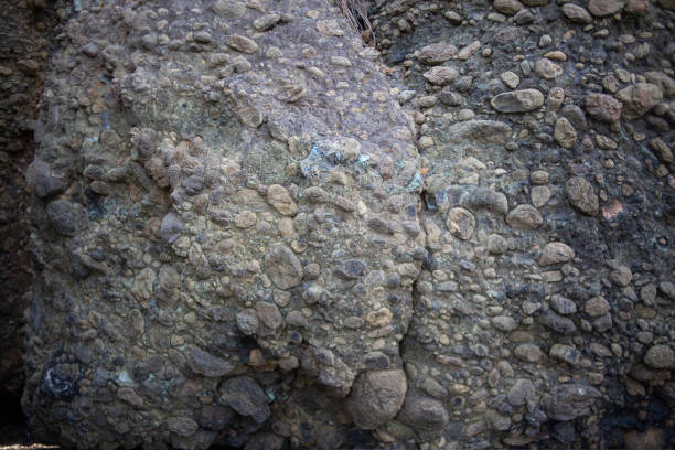 istock Natural stone background with rough textured surface. Sea rock texture. close-up. Blurred and defocused background. 1439170887