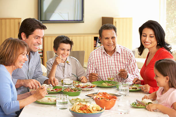 istock Extended Hispanic Family Enjoying Meal At Home 143917090