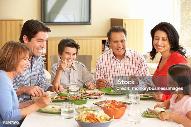 Extended Hispanic Family Enjoying Meal At Home Stock Photo - Download Image Now - Family, Dinner, Latin American and Hispanic Ethnicity