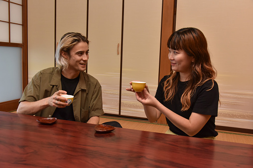 Japanese tourist drinking tea from fresh tea leaves, Shizuoka, Japan