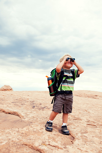 A young boy looks toward his next adventure. Plenty of copy space up top.