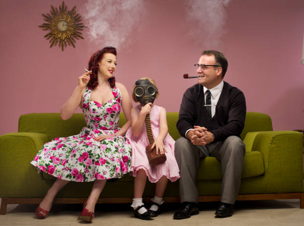 the family that smokes together 1950s retro family share the joy of smoking with their daughter gas mask stock pictures, royalty-free photos & images