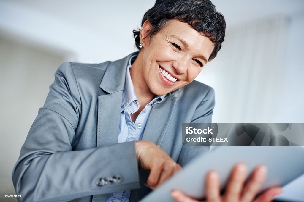 Happy business woman using digital tablet  50-59 Years Stock Photo