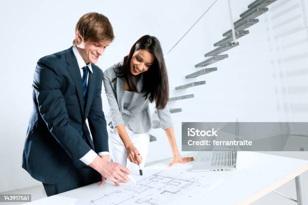 Two Architects Working On Blue Prints Stock Photo - Download Image Now - Discussion, Renovation, 25-29 Years