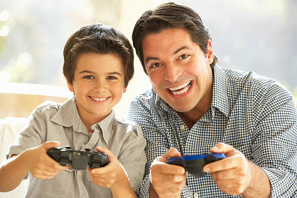 istock Father And Son Playing Video Game At Home 143917574