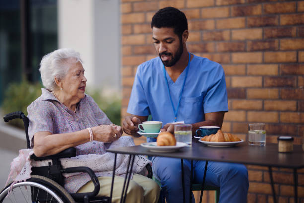 istock Caregiver having breakfast with his client at cafe. 1439175782