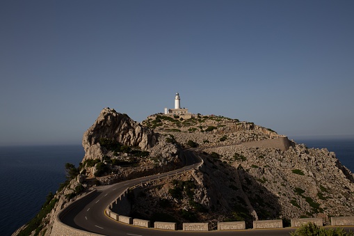 A road leading to the lighthouse on an island