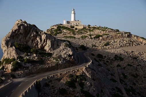 A road leading to the lighthouse on an island
