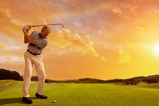istock Golfer Prepares to Strike Ball At Sunset 143917637