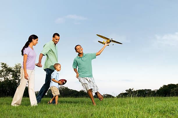 Family walking through field with children.