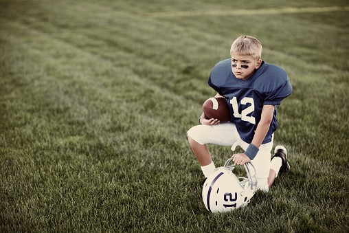 Portrait of a young American boy ready to take the football field.