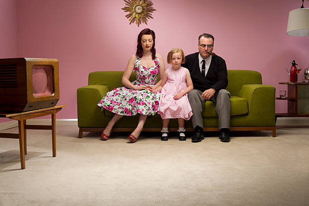 unhappy retro family 1950s family stare at the floor family photo on wall stock pictures, royalty-free photos & images