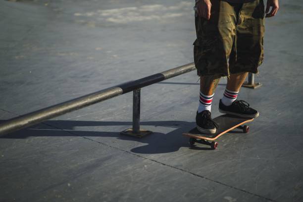 istock Young male doing different tricks with a skateboard in the park 1439178662
