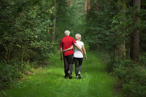istock Rear view on loving senior couple walking in forest (XXXL) 143917901