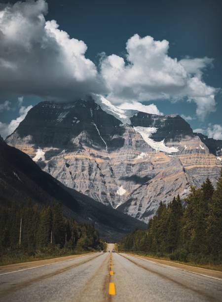 istock Vertical shot of an empty road with mountain range in the background in Canada 1439179732
