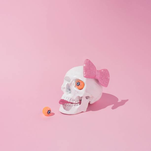 istock Skull with a pink bow tie and tongue sticking out 1439180022