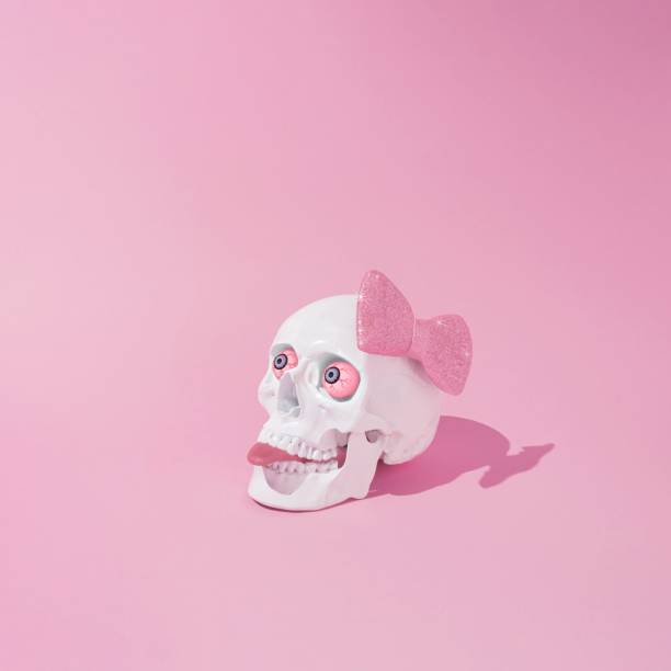istock Skull with a pink bow tie and tongue sticking out 1439180023