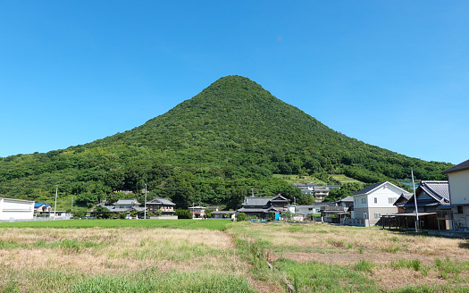 On a sunny day in August 2022, Mt. Iino, also known as Sanuki Fuji, shines against the blue sky in Marugame City, Kagawa Prefecture, also known as \